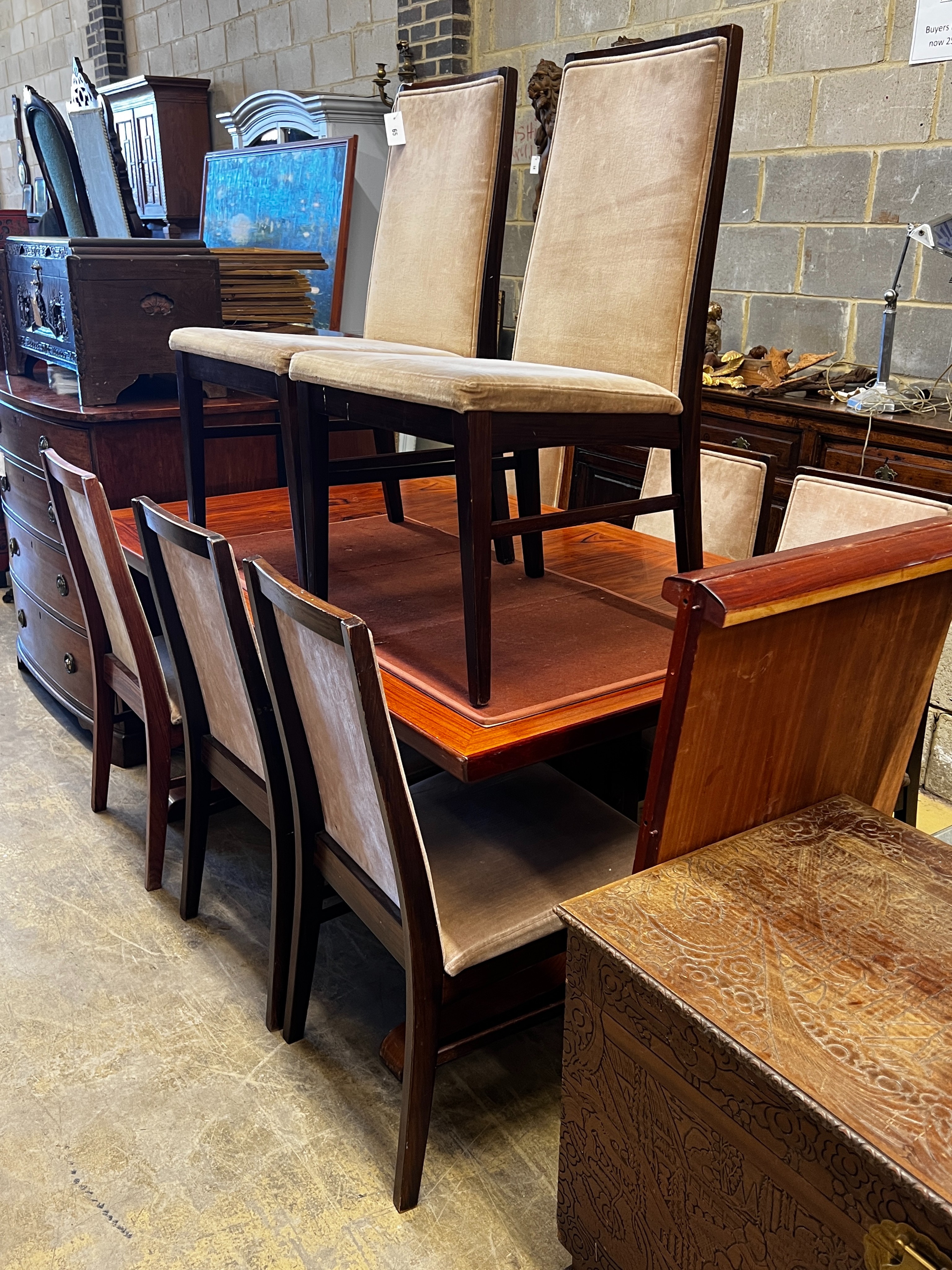 A mid century design hardwood extending dining table, length 265cm extended, two spare leaves, depth 99cm, height 72cm and eight chairs